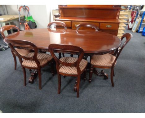 A good quality carved reproduction mahogany twin pedestal dining room table together with six Victorian style dining room cha