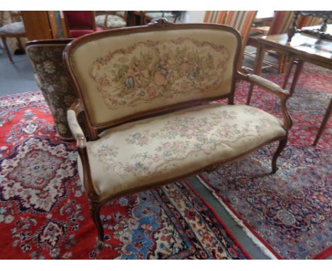 A continental beech framed settee in tapestry fabric 