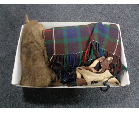 A box of fur and leather gauntlets, woolen rug and a skull cap