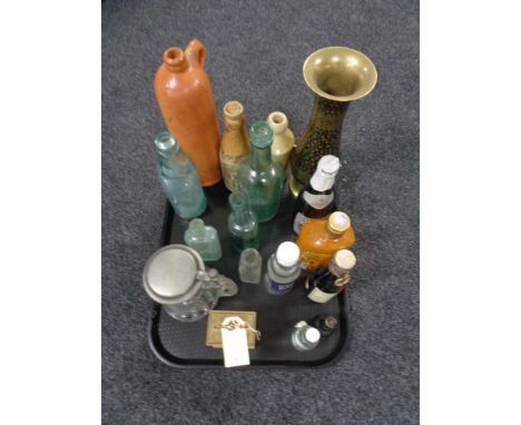 A tray of antique glass and stoneware bottle, brass carriage clock, bottles of alcohol 