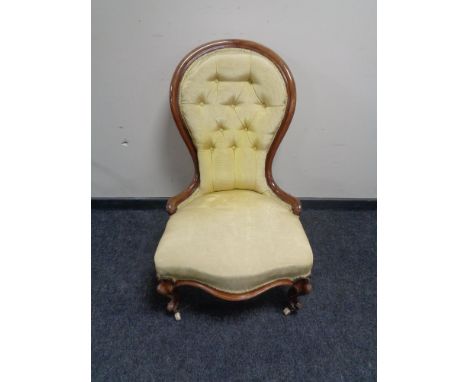A Victorian button back lady's chair in gold fabric 
