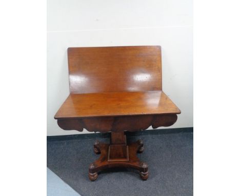 A Victorian mahogany pedestal turnover top table 