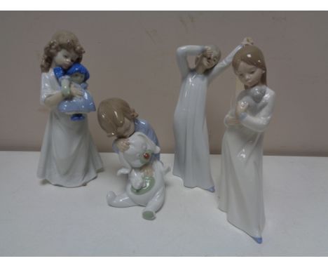 Four Nao figures of children in night dress. 