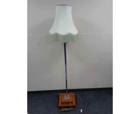 An Art Deco walnut and chrome standard lamp with green tasseled shade 