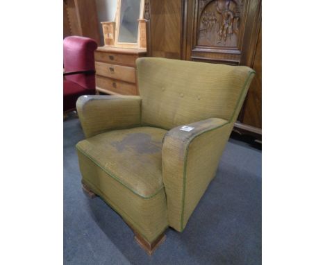 An Edwardian button back armchair 