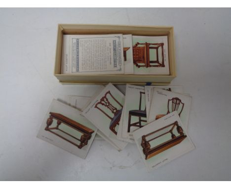 A Wills cigarette card albums with cigarettes and a box of Wills Old Furniture cigarette cards 
