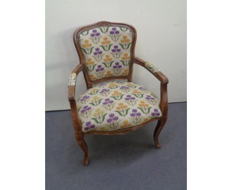 A continental beech framed armchair in tapestry fabric 