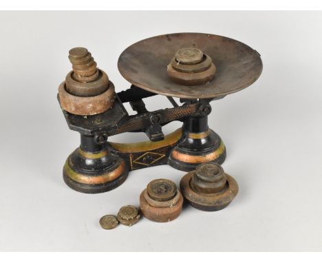 A Set of Gilt Decorated Black Painted Kitchen Scales together with Unrelated Weights