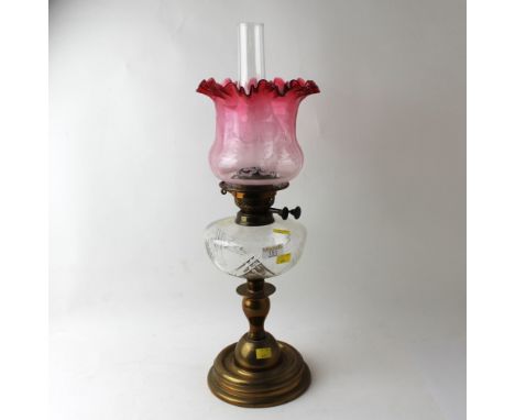 British made brass oil lamp with etched cranberry shade, 60 cm high