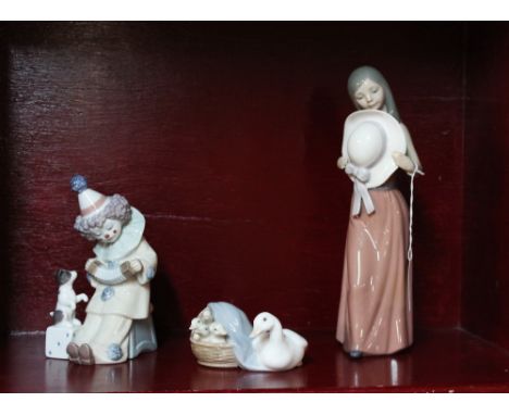 Three Lladro figurines, girl with hat, clown with puppy and geese 