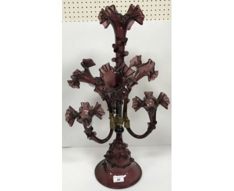 A Bohemian amethyst glass epergne in the 19th Century style with seven trumpet shaped flower holders on a conical base 61 cm 