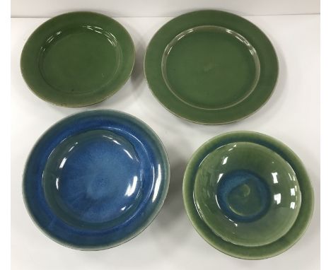 A Rupert Spira studio pottery blue glazed bowl with wide rim, raised on a shallow foot, 25 cm diameter x 6 cm high, a similar