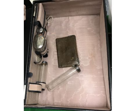 A leather covered vanity case bearing initials "E.G.G.", containing four silver topped dressing table jars / bottles, mirror 