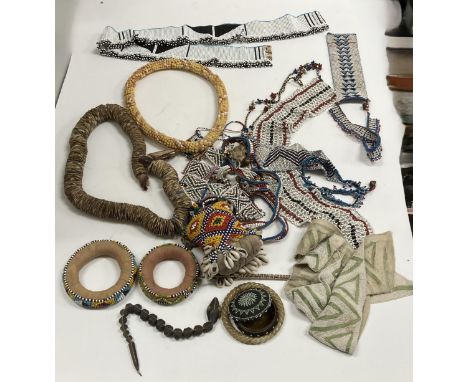 A collection of various African and other beadwork artifacts including a beadwork and cowrie shell medicine bottle with pincu