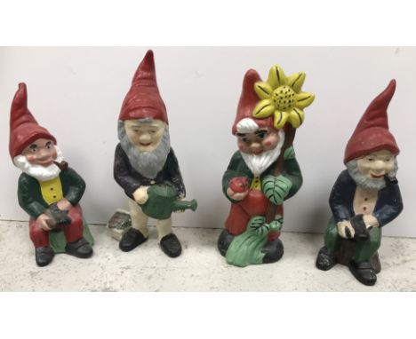 A box containing assorted painted garden gnomes and first day covers, a box containing assorted decorative collectors type pl