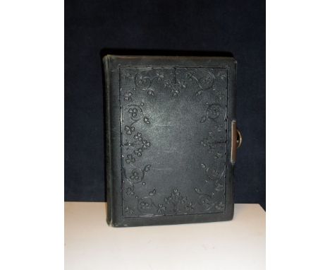 A late Victorian family portrait photograph album, carte de visite and larger size mounts, with embossed leather cover and cl