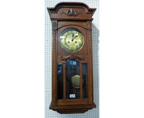 An oak cased wall clock