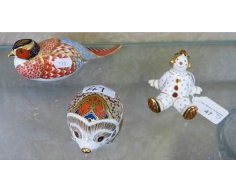 Royal Crown Derby paperweights of pheasant, hedgehog and clown two lacking stoppers, one with gold stopper