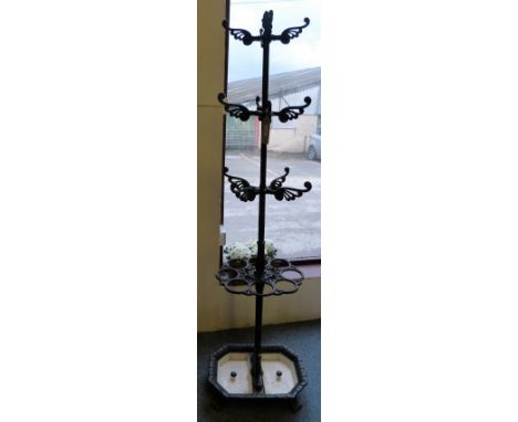 A Victorian cast-iron hallstand, the central column with three tiers of coat hooks over eight stick apertures on octagonal ba