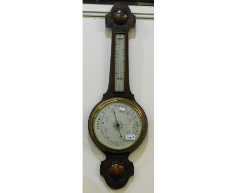 A carved oak framed aneroid barometer 