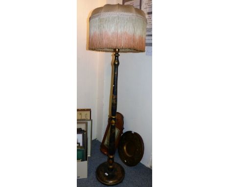 An lacquered standard lamp with frilled shade, the stem and base bearing chinoiserie scenes