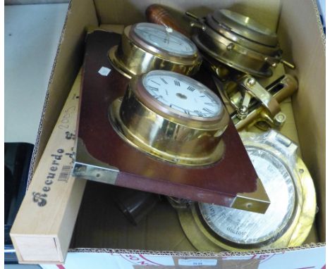 A brass cased wall clock in the form of a ships wheel, a brass table mounting cork screw, a barometer and clock mounted on wo