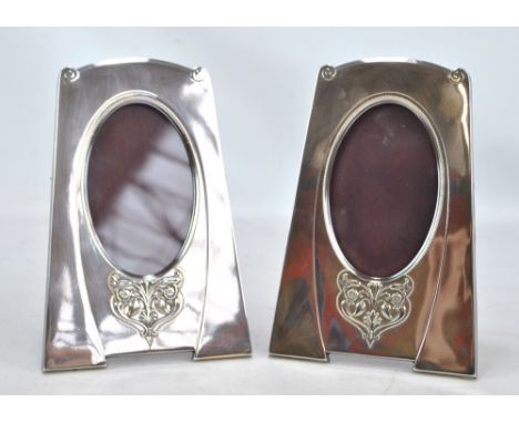 WMF; a pair of early 20th century silver plated Secessionist style photo frames of tapering forms with bracket feet, each emb