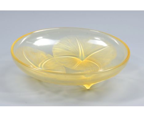 LALIQUE; an orange/yellow tinted shallow bowl decorated with three lily pads, etched signature 'R Lalique, France' and number