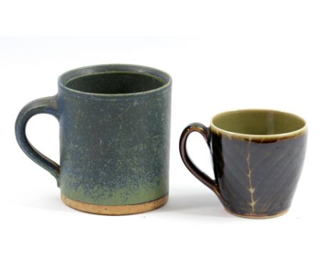 ROBIN WELCH (born 1936); a large stoneware mug covered in mottled dark blue glaze on a sea green ground, impressed mark, heig