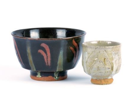 JIM MALONE (born 1946); a stoneware footed bowl covered in tenmoku glaze with finger wipe decoration and running green lines,