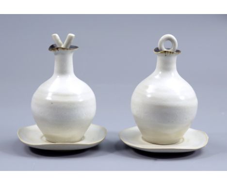 LUCIE RIE (1902-1995); a stoneware oil and vinegar set, pitted white glaze with manganese rims, stoppers modelled as an 'O' a