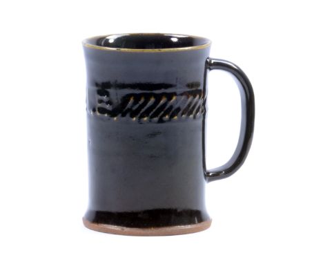 BERNARD LEACH (1887-1979) for Leach Pottery; an early stoneware ale tankard covered in tenmoku glaze, impressed BL and potter