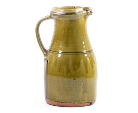 RICHARD BATTERHAM (born 1936); a stoneware jug covered in green ash glaze, height 30cm. (D)   CONDITION REPORT:  Appears good
