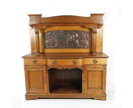 A Liberty & Co oak sideboard, two cabinets flanking central aperture, below large copper panel by John Pearson, repousse hamm