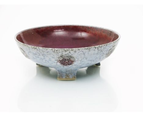 A Ruskin Pottery high-fired stoneware bowl on three feet by William Howson Taylor,  dated 1927, the  exterior modelled in low