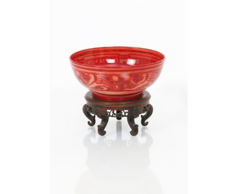 A Bernard Moore flambe bowl by R R Tomlinson, painted to the well with a winged heraldic lion passant, incised border with in
