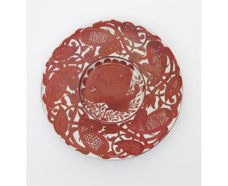 A small William De Morgan pottery charger, painted to the well with a peacock, the rim with frieze of scrolling, intertwined 