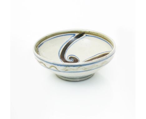 •Seth Cardew (born 1934) a  Wenford Bridge stoneware bowl, painted to the well with radiating scroll design in blue and brown
