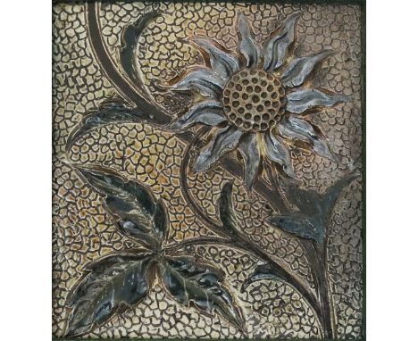A Martin Brothers stoneware tile, modelled in low relief with a sunflower, glazed green and brown, framed 13.5 x 14.5cm.,