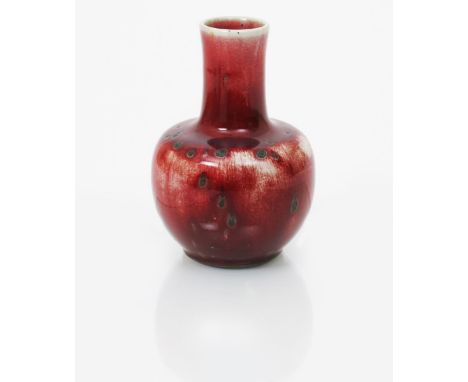 A Ruskin Pottery high-fired stoneware vase by William Howson Taylor, dated 1933, ovoid with cylindrical neck, covered in a st