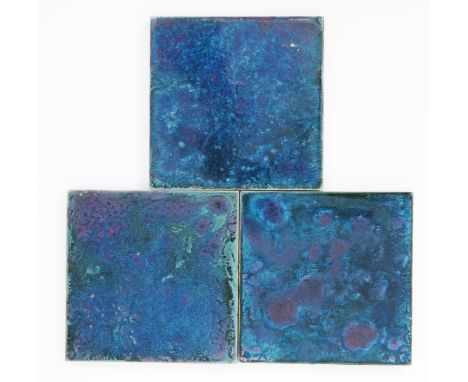 Three Ruskin Pottery stoneware tiles by William Howson Taylor, each covered in a deep green-blue souffle glaze, splashed with