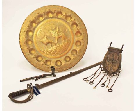 EARLY/MID 20TH CENTURY NIGERIAN CAST METAL SPORRANalong with a pipe, a dress sword, and a circular brass Libyian charger, 51c