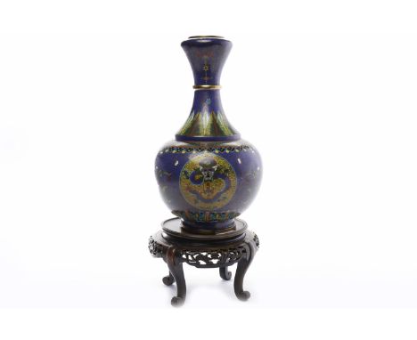 CLOISONNE ENAMEL VASEdecorated with flowers and dragon serpents, 34cm high; along with a wood stand