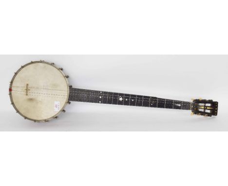 Interesting five string banjo branded Grade 5 behind the open peg box, with closed floral pressed back, with 9" skin and 26" 