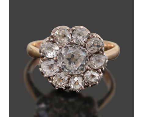 A diamond-set cluster ring, set with cushion-shaped old brilliant-cut diamonds, partially closed-back silver and yellow gold 