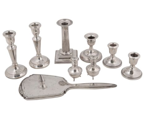 A collection of silver to include assorted dwarf candlesticks with weighted bases, a pair of George V pepper casters and a ha