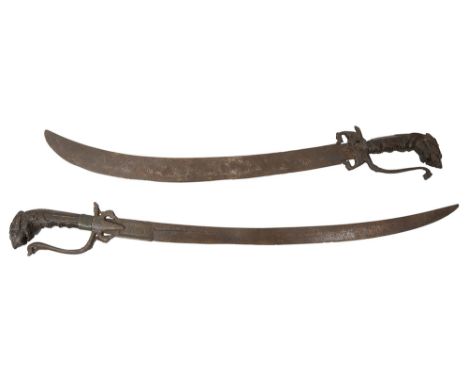 Two Kastane swordsCeylonese / Sri Lankan, 19th century, each with curved blade, the first with fullered blade, etched to rica