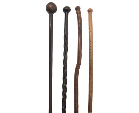 Two Southern African tribal hardwood knobkerries and two walking canes probably Zulufirst having incised cross hatched grip a