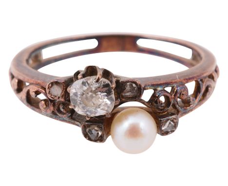 A late 19th century/early 20th century diamond and pearl ringthe cushion-shaped old brilliant-cut diamond obliquely-set with 