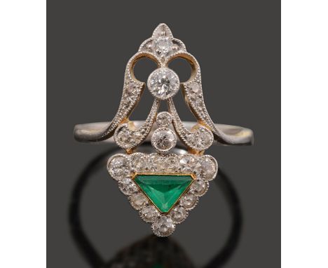 An unusual early 20th emerald and diamond-set ringthe triangular emerald and diamond-set surmount to the ornate open work dia